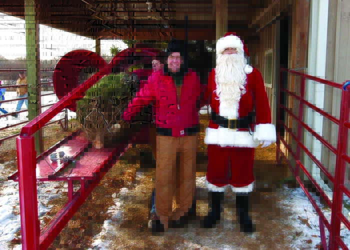 Dr. Pete Mutch at the tree farm with Santa.