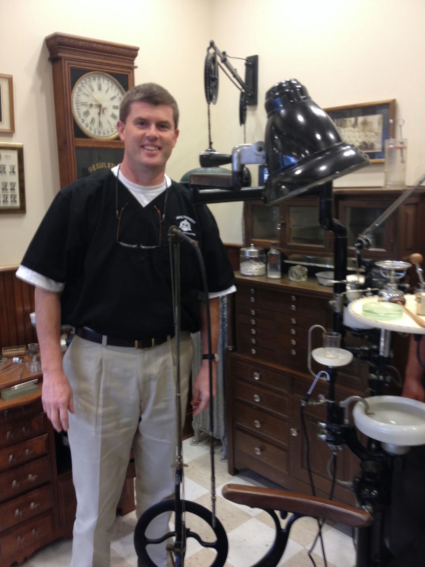 Third-generation Alabama dentist, Dr. H. Paul Hufham III, with his grandfather’s dental equipment, on display for all of his patients in Dothan.