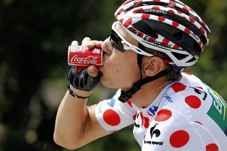 French cyclist Pierre Rolland drank a soda while riding in the 2013 Tour de France. 