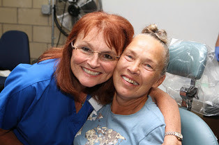 Chair of Dental Health and Program Director of Dental Hygiene, Kathleen Gazzola, at left, notes that in collaboration with the Rhode Island Oral Health Foundation they are hosting the fourth Rhode Island Mission of Mercy here at Community College of Rhode Island. She is shown at the 2013 Mission of Mercy with a patient.