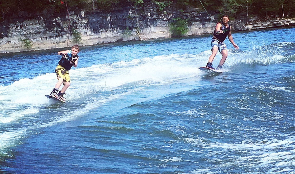 Image of Dr. Jackson wake boarding with son at Big Cedar.