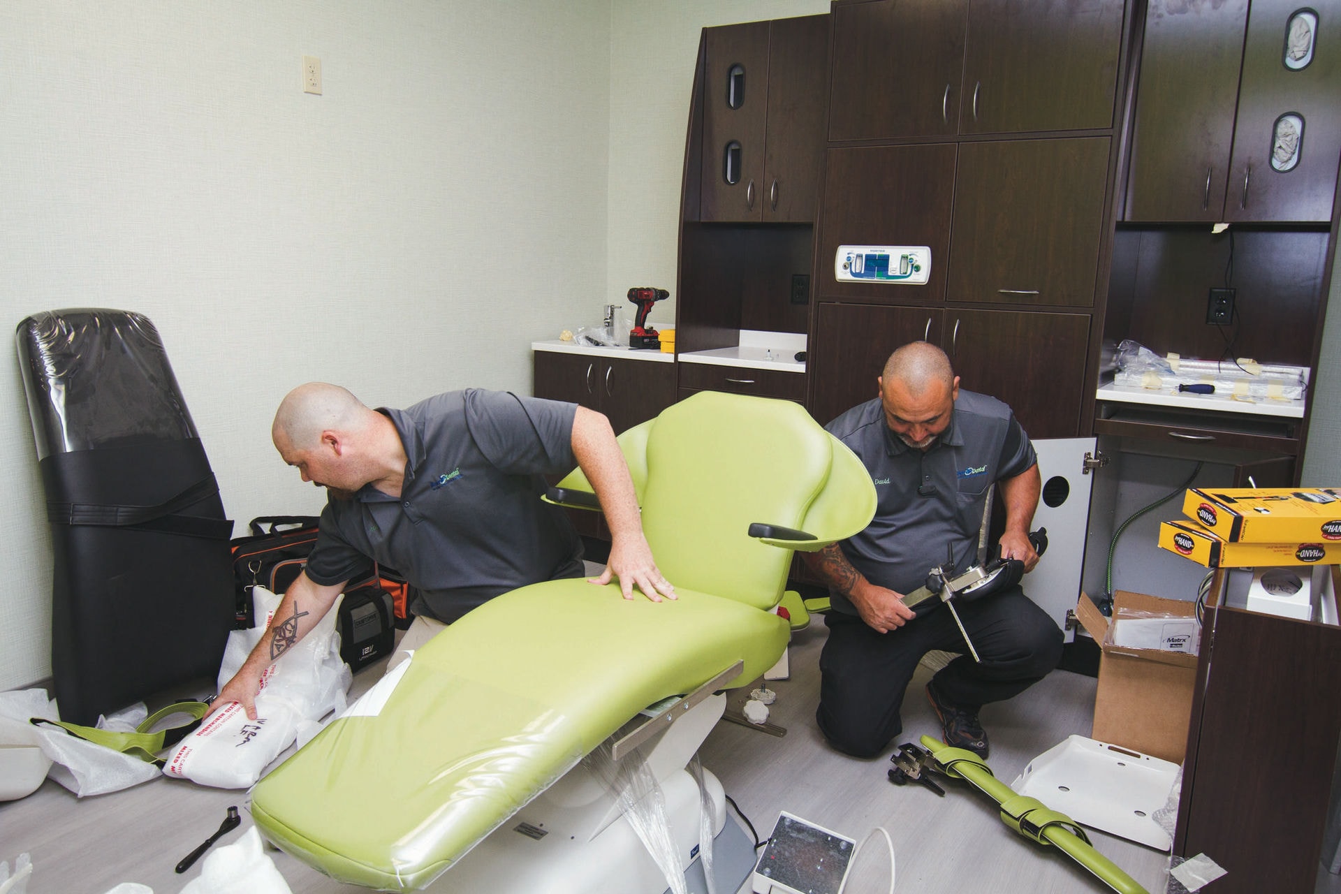 Two Benco staff members assemble a dental chair.