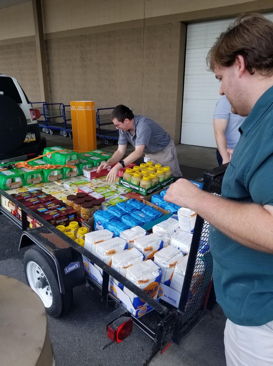 Benco associates unload a trailer full of non-perishables donated by the IT department.