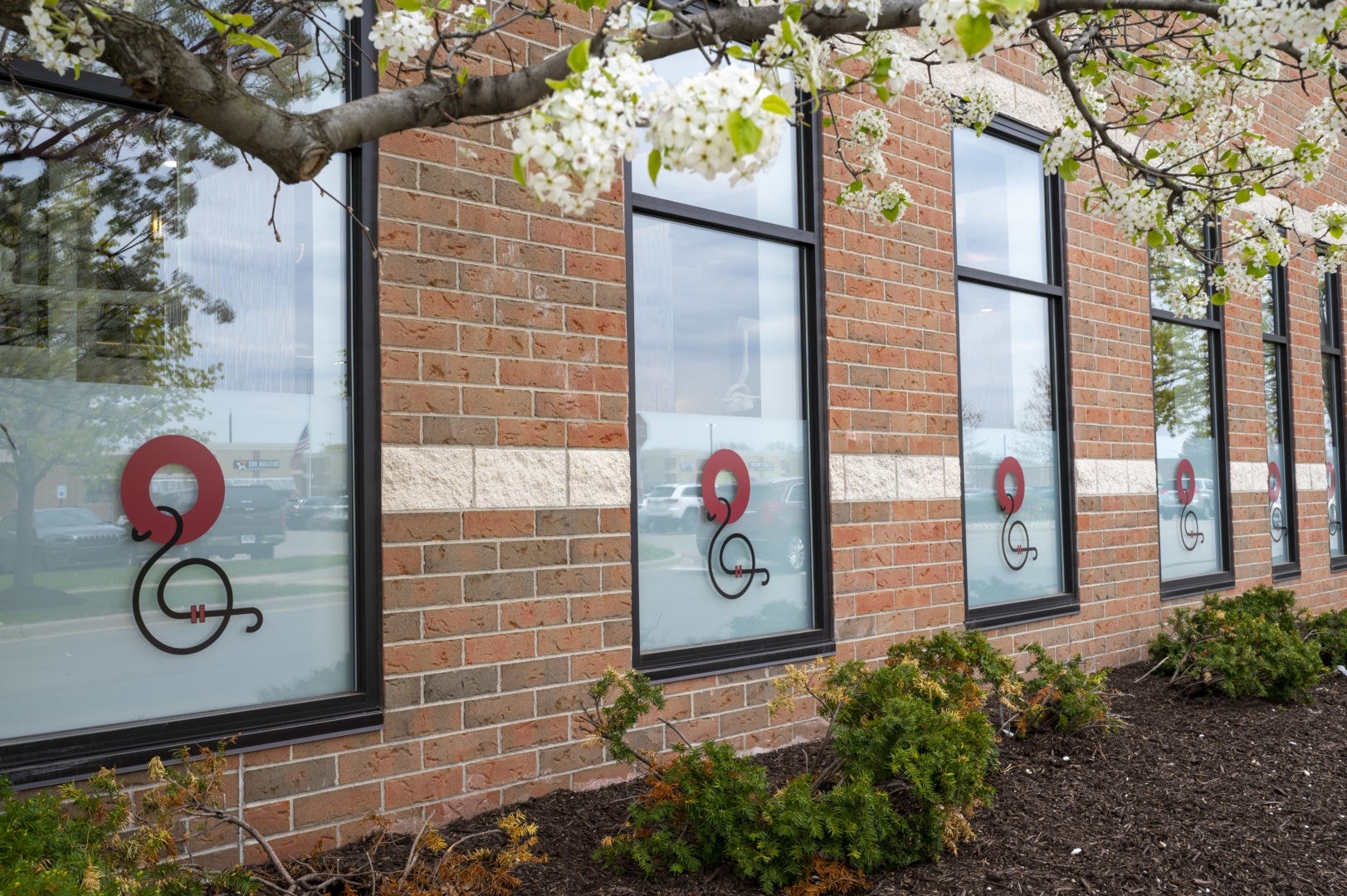 Exterior view of the windows of Oakland Orthodonics featuring the dental practice's logo.