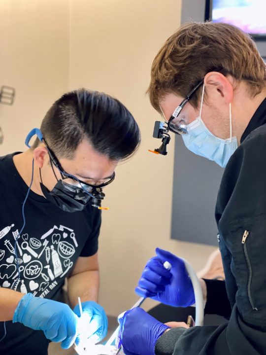 Apex Dental Studio Founder Dr. Andy Tran and RDA Justin offer treatment to a patient during free Dentistry Day on April 20.