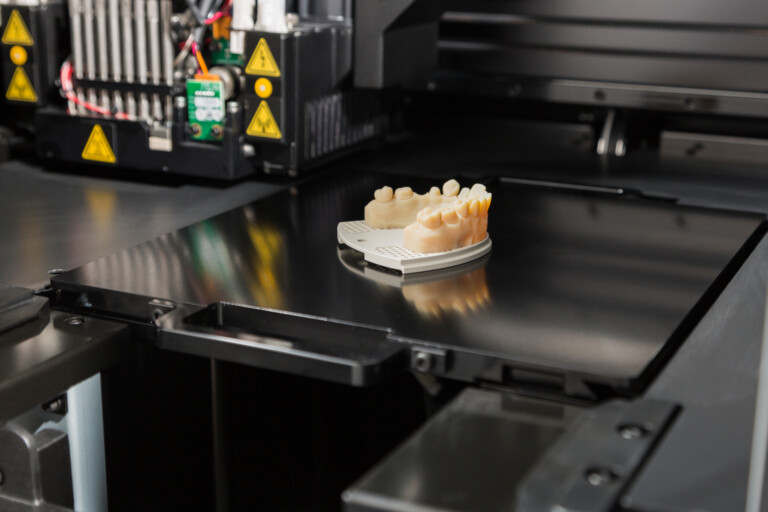 3D Printer With Finished 3D Printed Dental Implant Bridge.