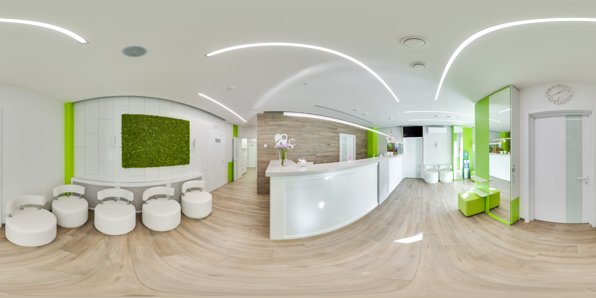 A wide angle view of an empty reception area featuring accents of bright orange.